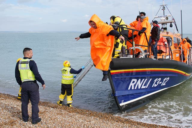 A group of people thought to be migrants are brought in to Dungeness beach (Gareth Fuller/PA)