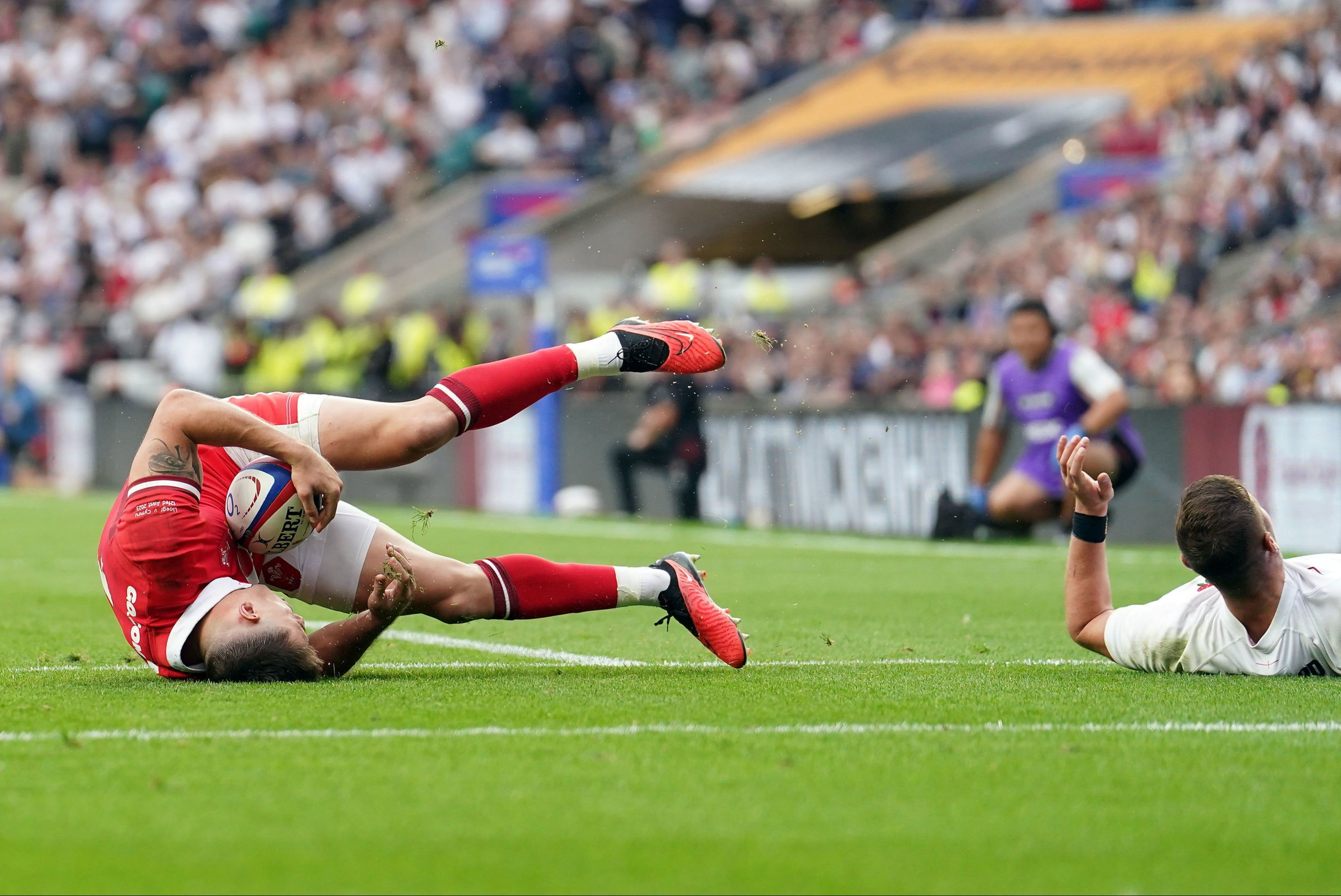 England's Freddie Steward tackles Wales' Josh Adams in the air