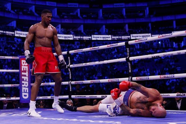 <p>Anthony Joshua stands over a beaten Robert Helenius in the seventh round of Saturday’s fight at London’s O2 Arena </p>