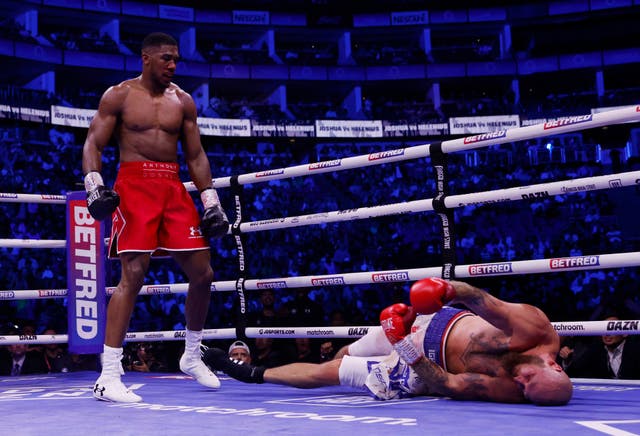 <p>Anthony Joshua stands over a beaten Robert Helenius in the seventh round of Saturday’s fight at London’s O2 Arena </p>