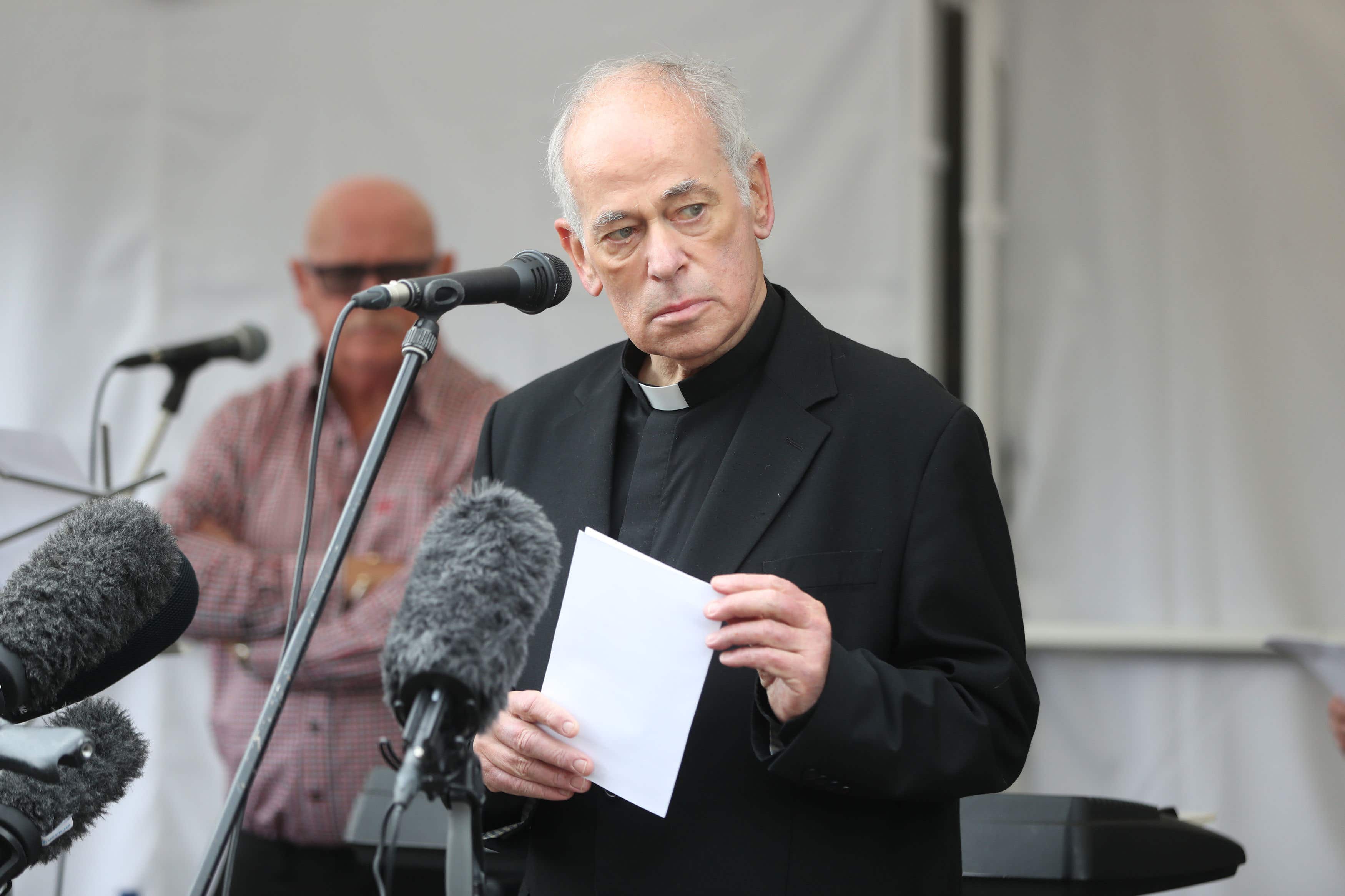 Fr Kevin Mullan reading a poem entitled A call to return (Niall Carson/PA)