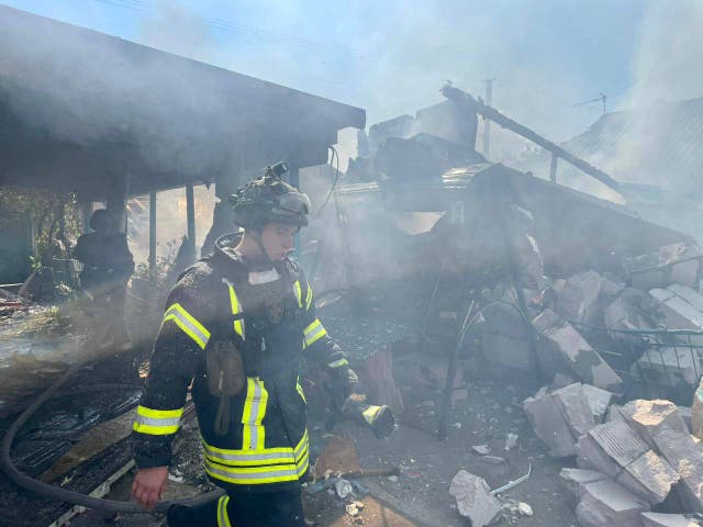 <p>Firefighters attend to a blaze in a residential area of Kherson after Russian attacks</p>