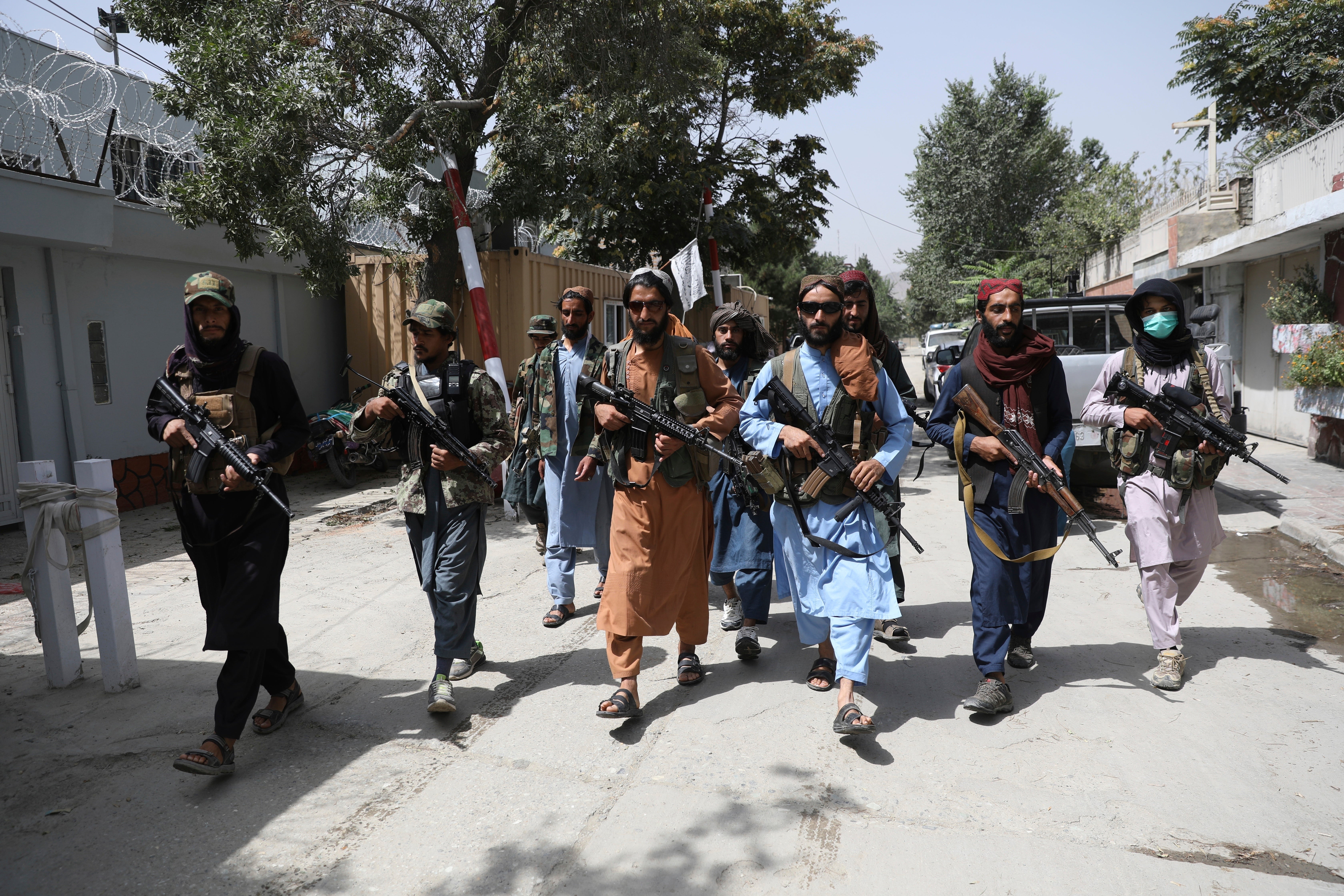 Taliban fighters patrol a neighbourhood in Kabul, days after it fell to the group