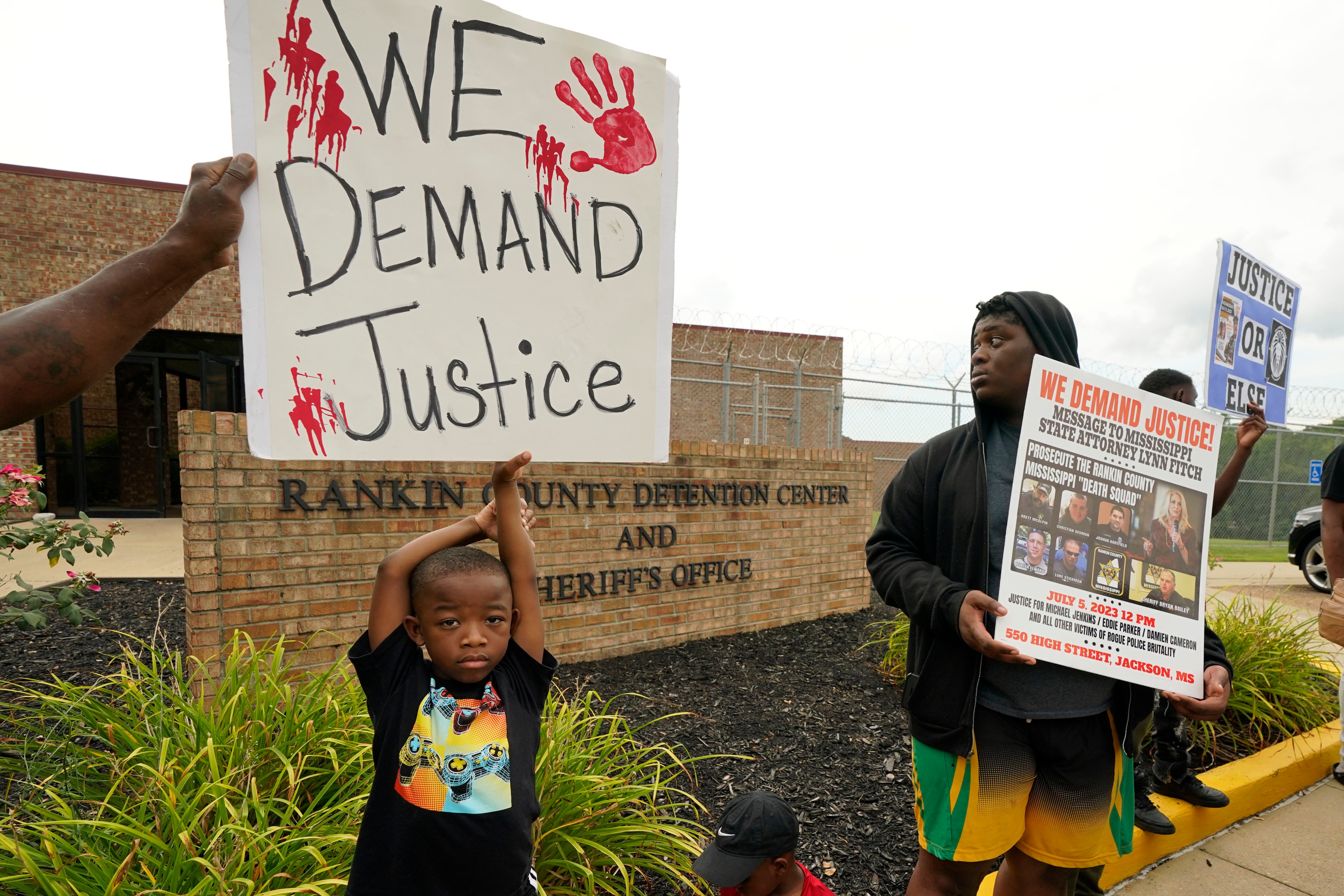 An anti-police brutality activist looks back at the entrance to the Rankin County Sheriff’s Office