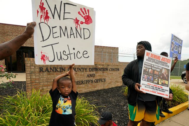 <p>An anti-police brutality activist looks back at the entrance to the Rankin County Sheriff's Office in Brandon, Mississippi on 5 July 2023 </p>