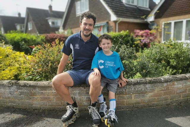 Dylan Almond, six, and dad Darren, 39, skating in Market Deeping for charity