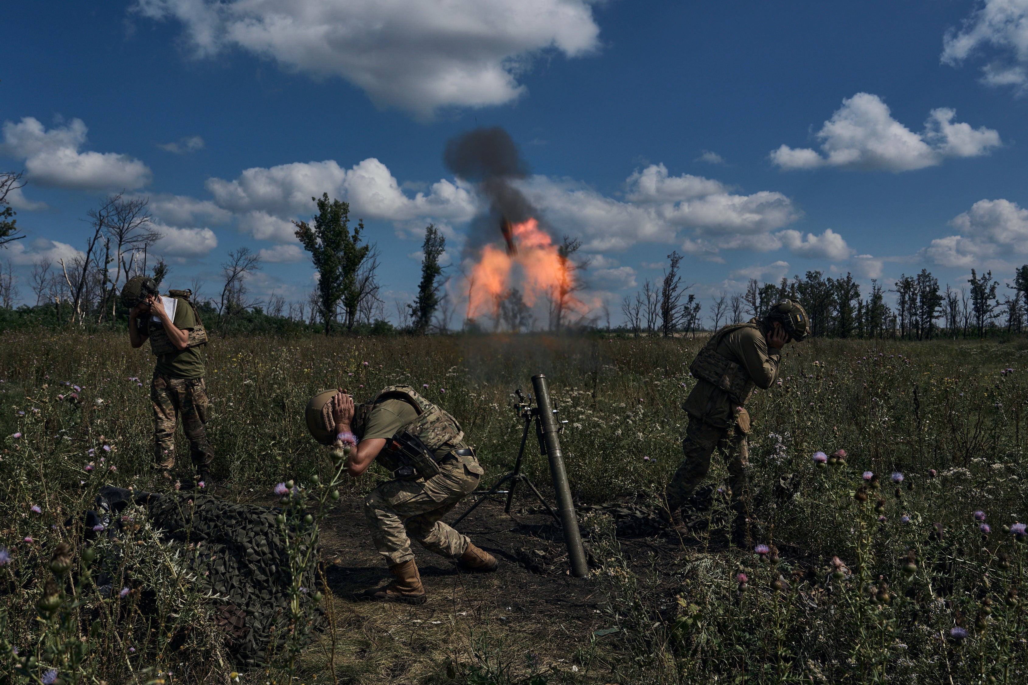 Ukrainian soldiers fire a mortar towards Russian positions at the front line, near Bakhmut