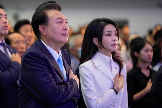 <p>South Korean President Yoon Suk Yeol, left, and his wife Kim Keon Hee react during a ceremony to celebrate the 78th anniversary of Korean Liberation Day from Japanese colonial rule in 1945, in Seoul, South Korea, Tuesday, 15 Aug 2023</p>