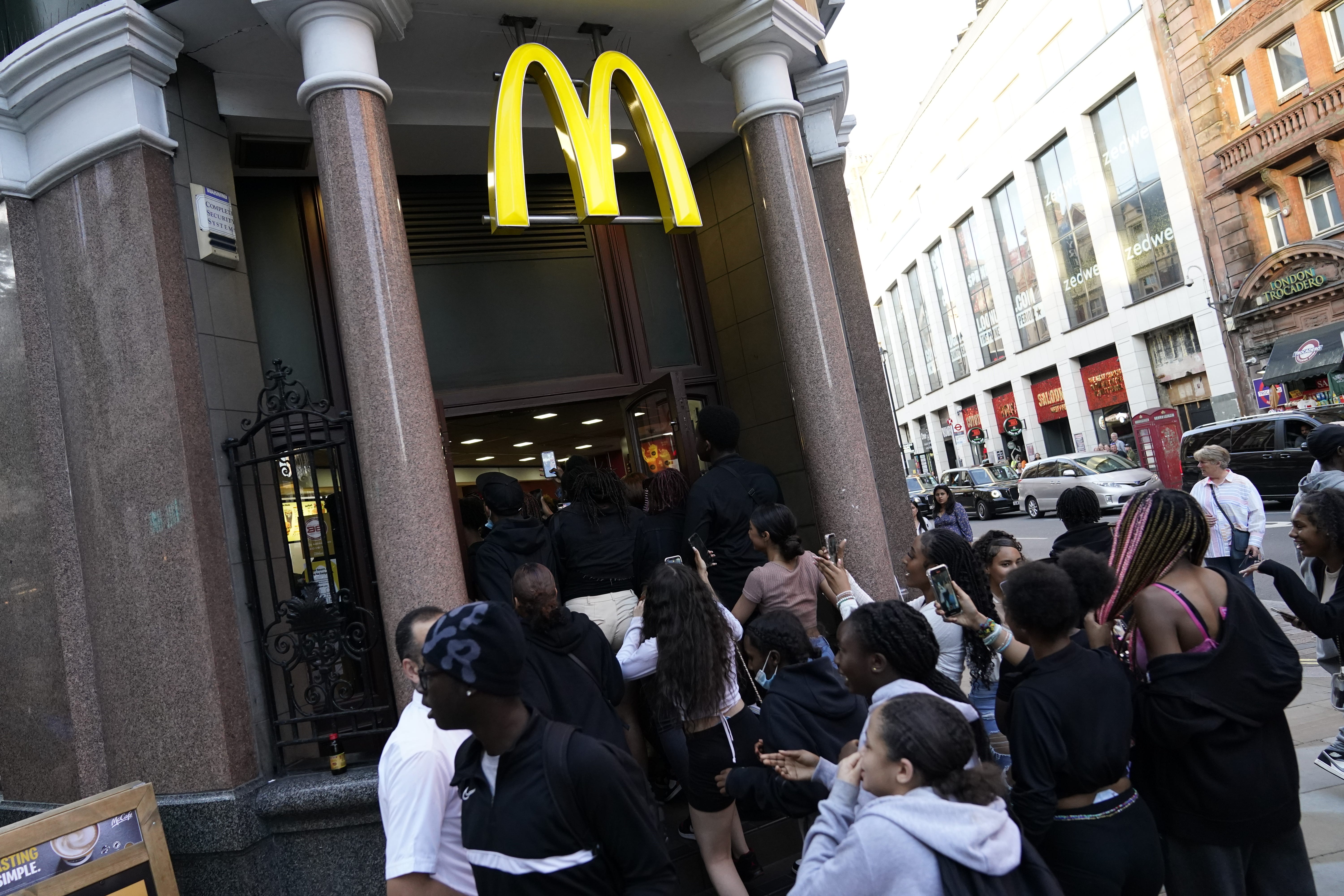 Youths run into a McDonalds store on Oxford Street in central London (Aaron Chown/PA)