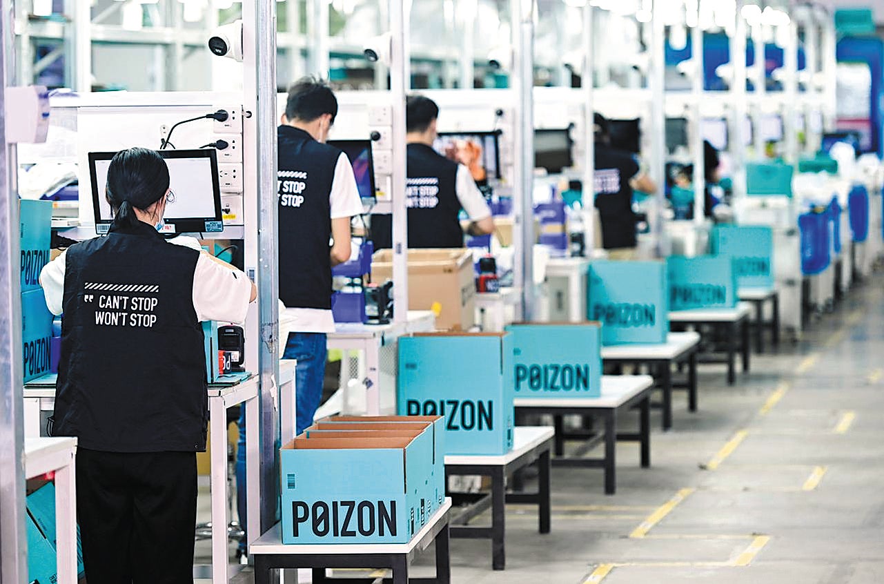 Employees of online fashion-brand provider Poizon check product quality in a factory in Shanghai in August 2022