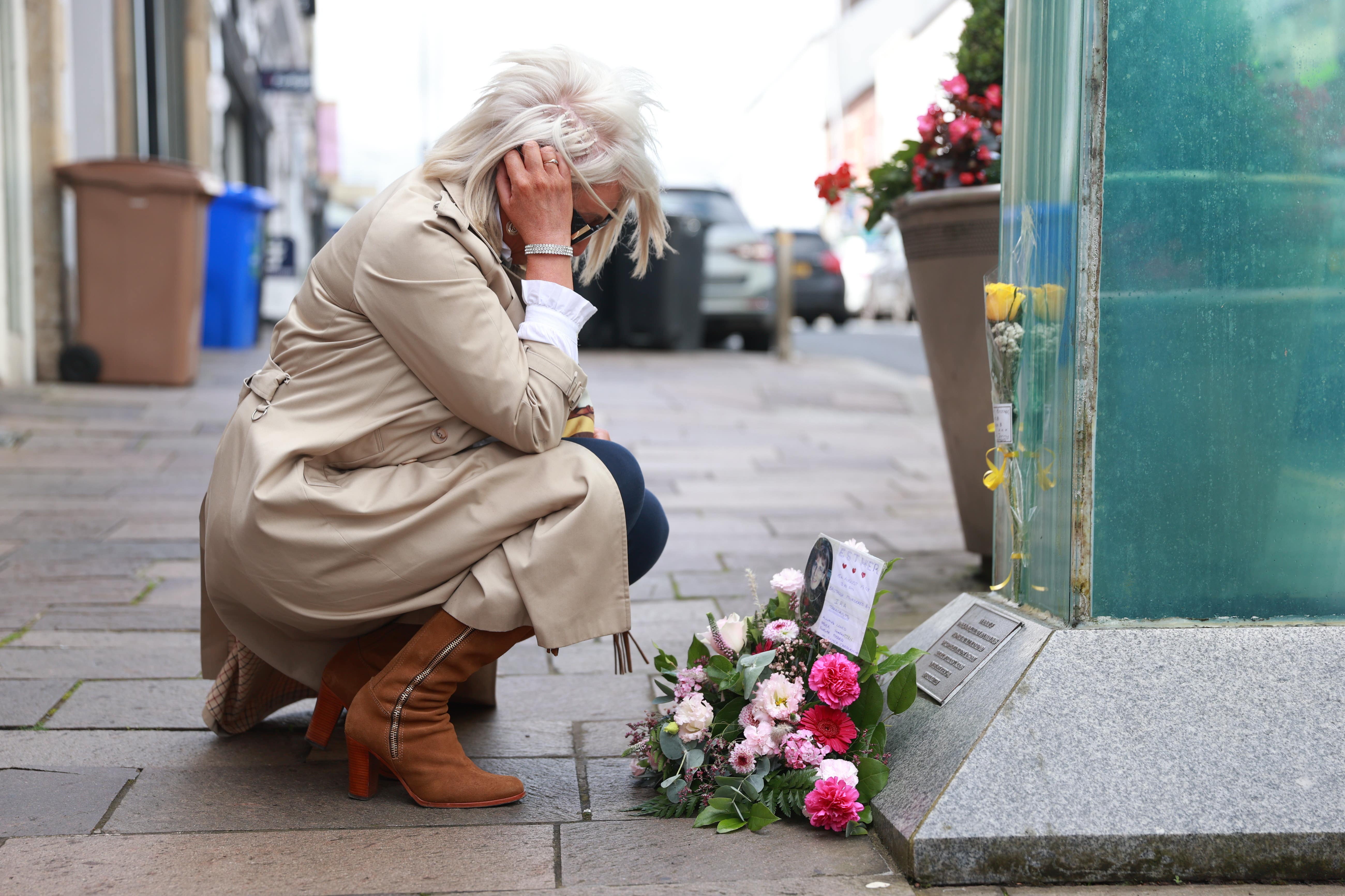 Caroline Martin, sister of Esther Gibson who died in the Omagh bombing, lays flowers at the site of the bombing to mark the 25th anniversary of the Real IRA atrocity (Liam McBurney/PA)