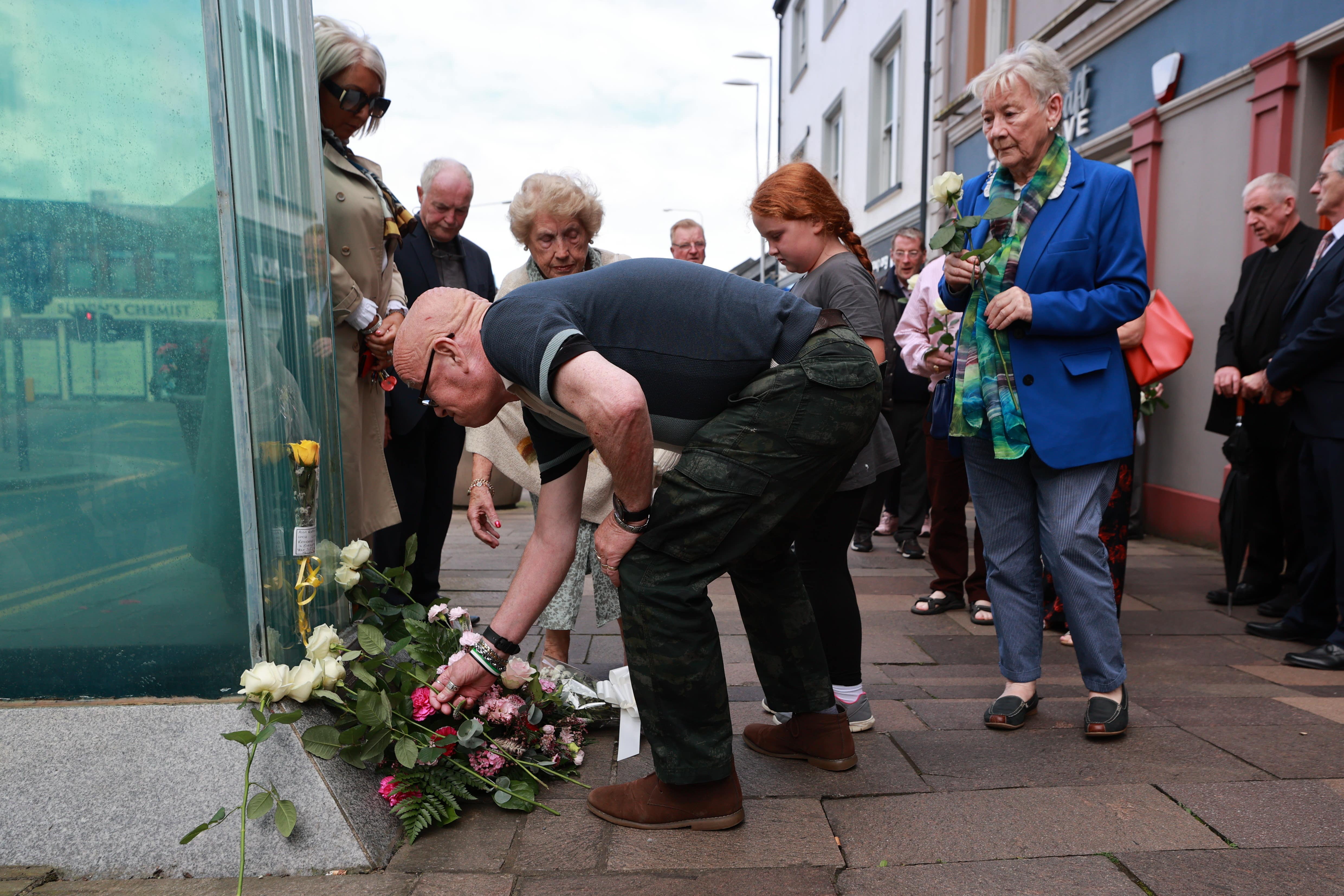 Kevin Skeldon, whose wife Philomena died in the Omagh atrocity, lays flowers at the site of the bombing to mark the 25th anniversary (Liam McBurney/PA)