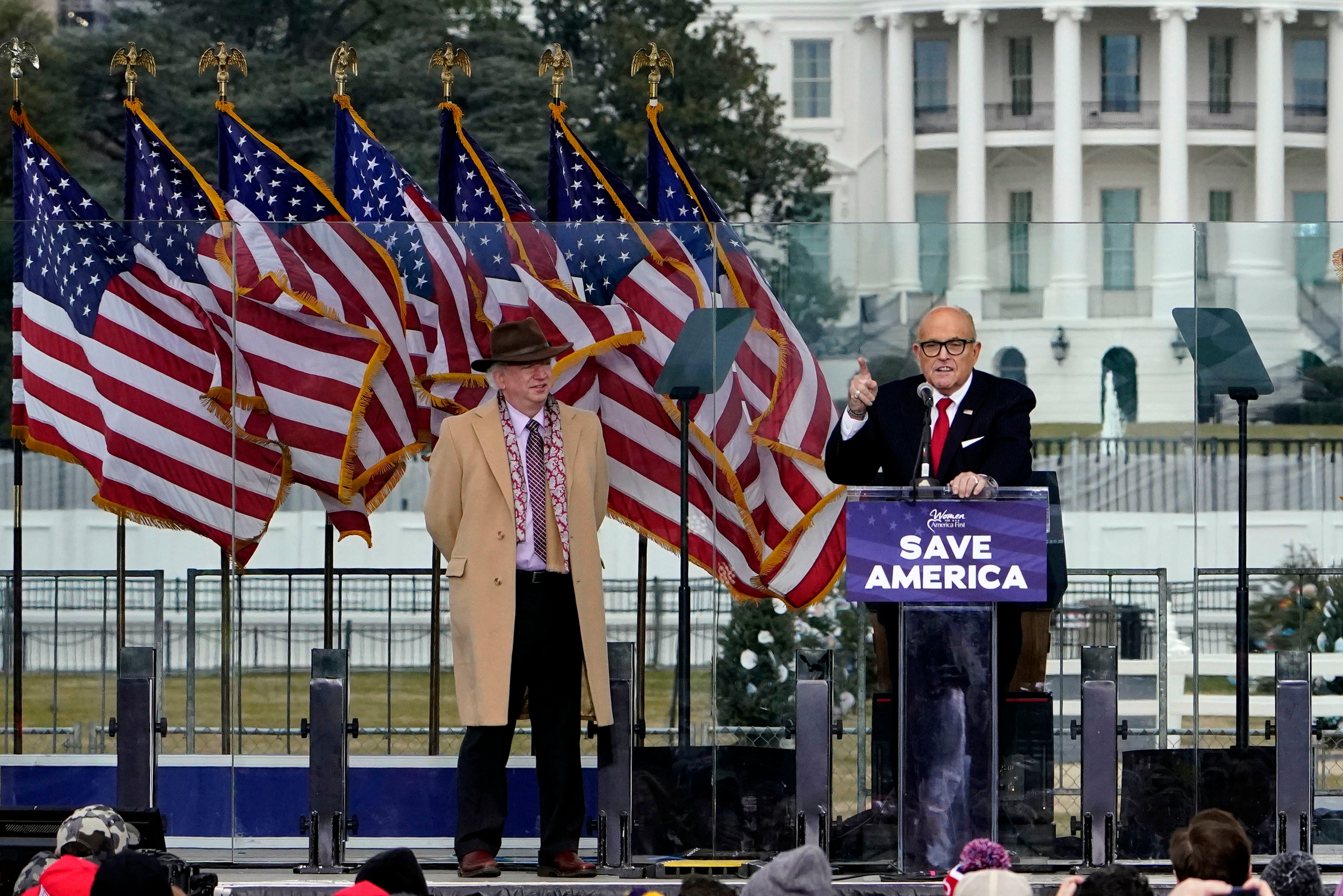 FILE - Chapman University law professor John Eastman stands at left as former New York Mayor Rudolph Giuliani speaks in Washington at a rally in support of President Donald Trump, called the "Save America Rally" on Jan. 6, 2021.