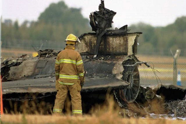 <p>US Air Force firecrews survey the wreckage of the U2 reconnaissance plane, which crashed during take-off 29 August from the former US Air Force base at Fairford, 70 miles west of London</p>