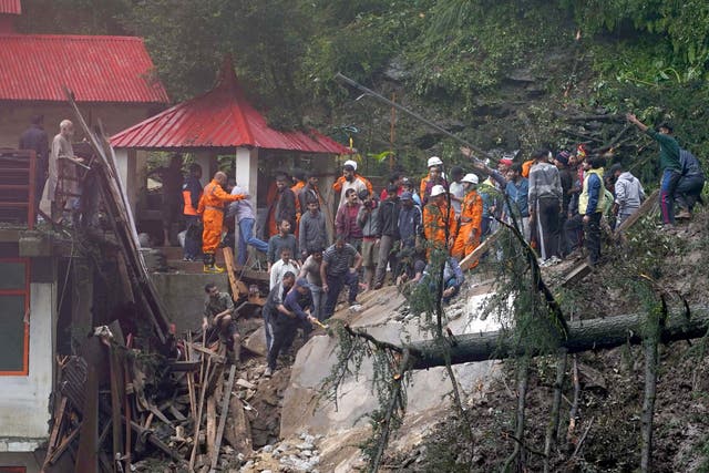 <p>Rescue workers remove the debris as they look for survivors after a landslide following torrential rain in Shimla, India</p>