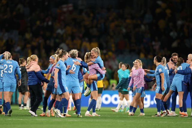 England players and staff celebrate after the final whistle of the semi-final (Isabel Infantes/PA)