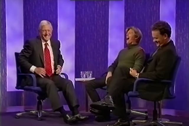 <p>Michael Parkinson chats with David Bowie and Tom Hanks during an episode of his eponymous chat show in 2002</p>