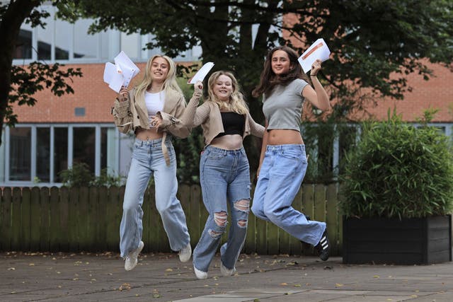 (Left-right) Ruby Devine, Rosemary Polland, and Alice Kelly receive their A-level results at Lagan College, Belfast (Liam McBurney/PA)