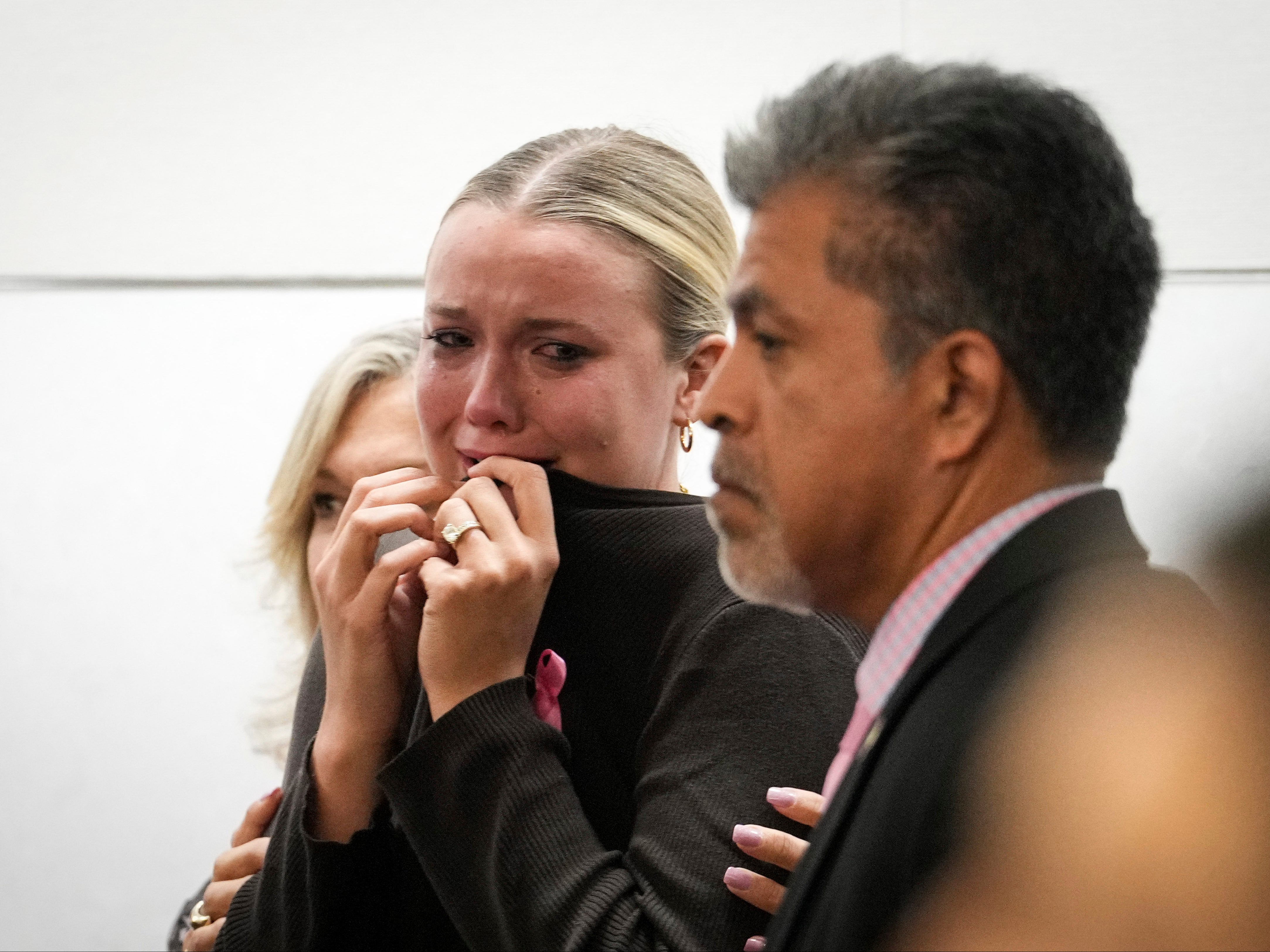 Kate Ober, wife of Antonio Armstrong Jr, cries as she listens to the verdict