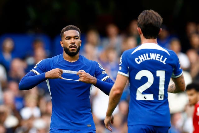 <p>Reece James hands the captain’s armband to Ben Chilwell before coming off against Liverpool</p>