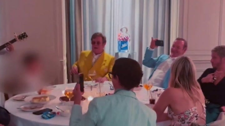 Elton John and Kevin Spacey sing Elvis hit while enjoying meal out.