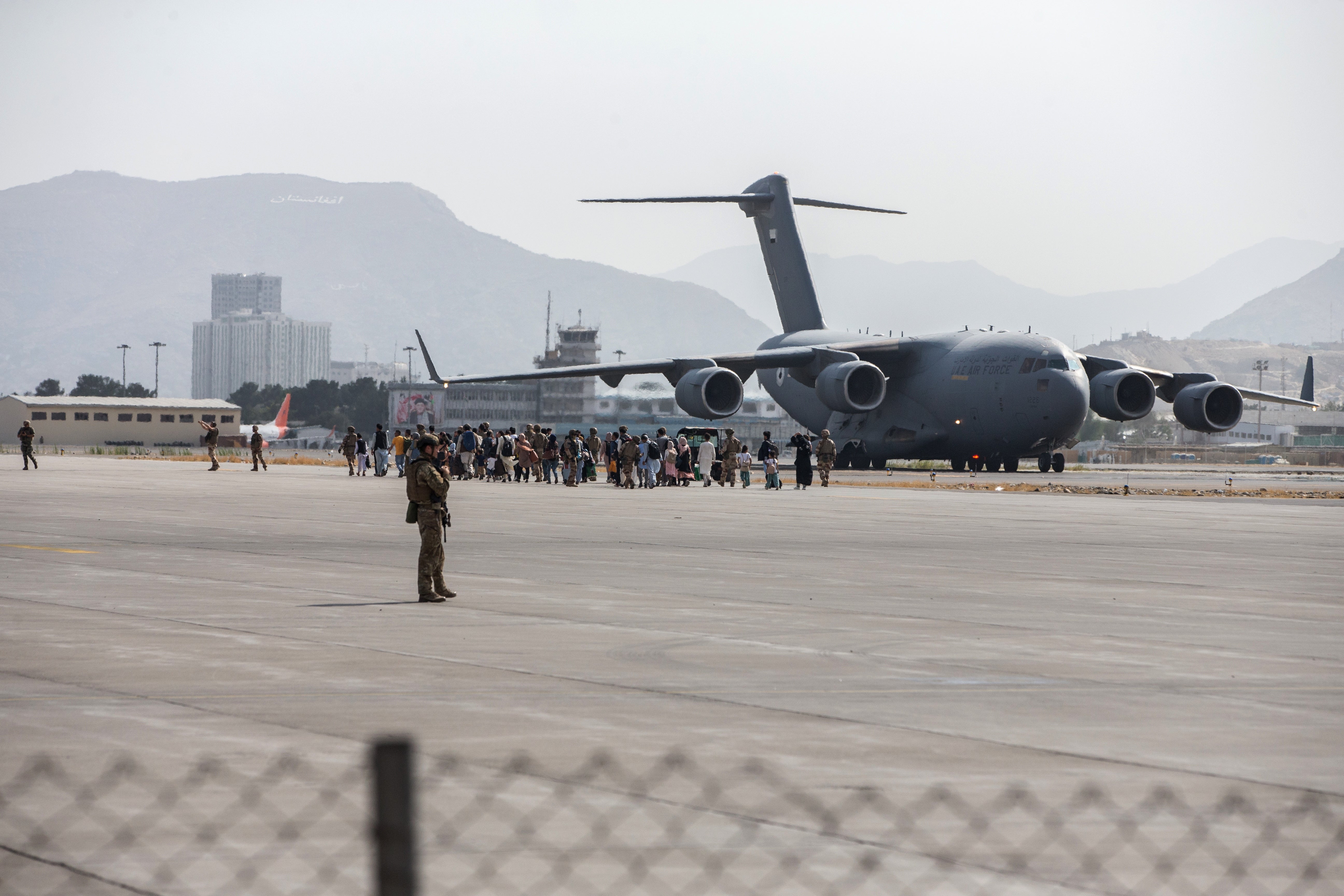 Evacuees swarm a US aircraft departing Kabul during the 2021 withdrawal from Afghanistan.