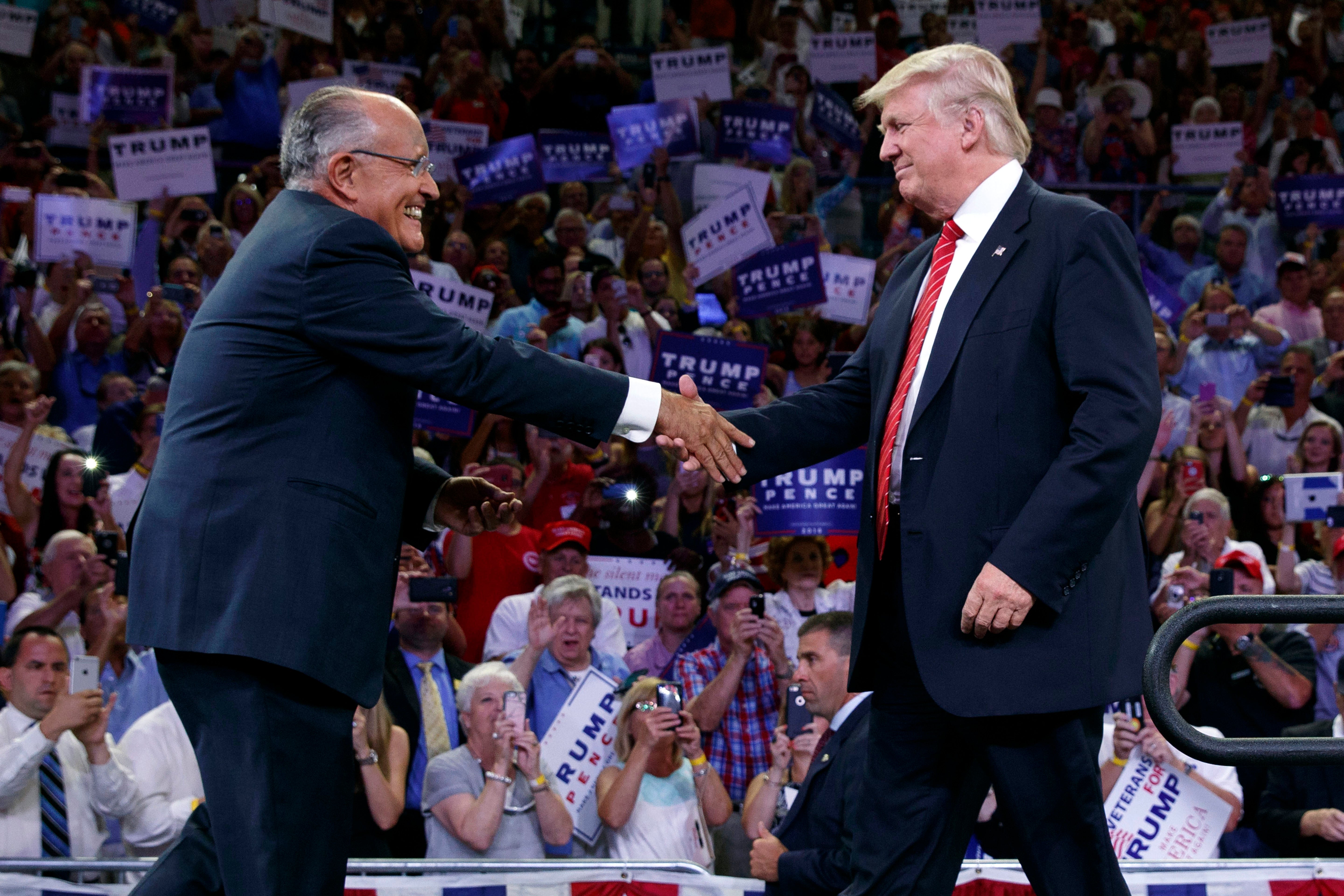 Giuliani greets Donald at a campaign rally