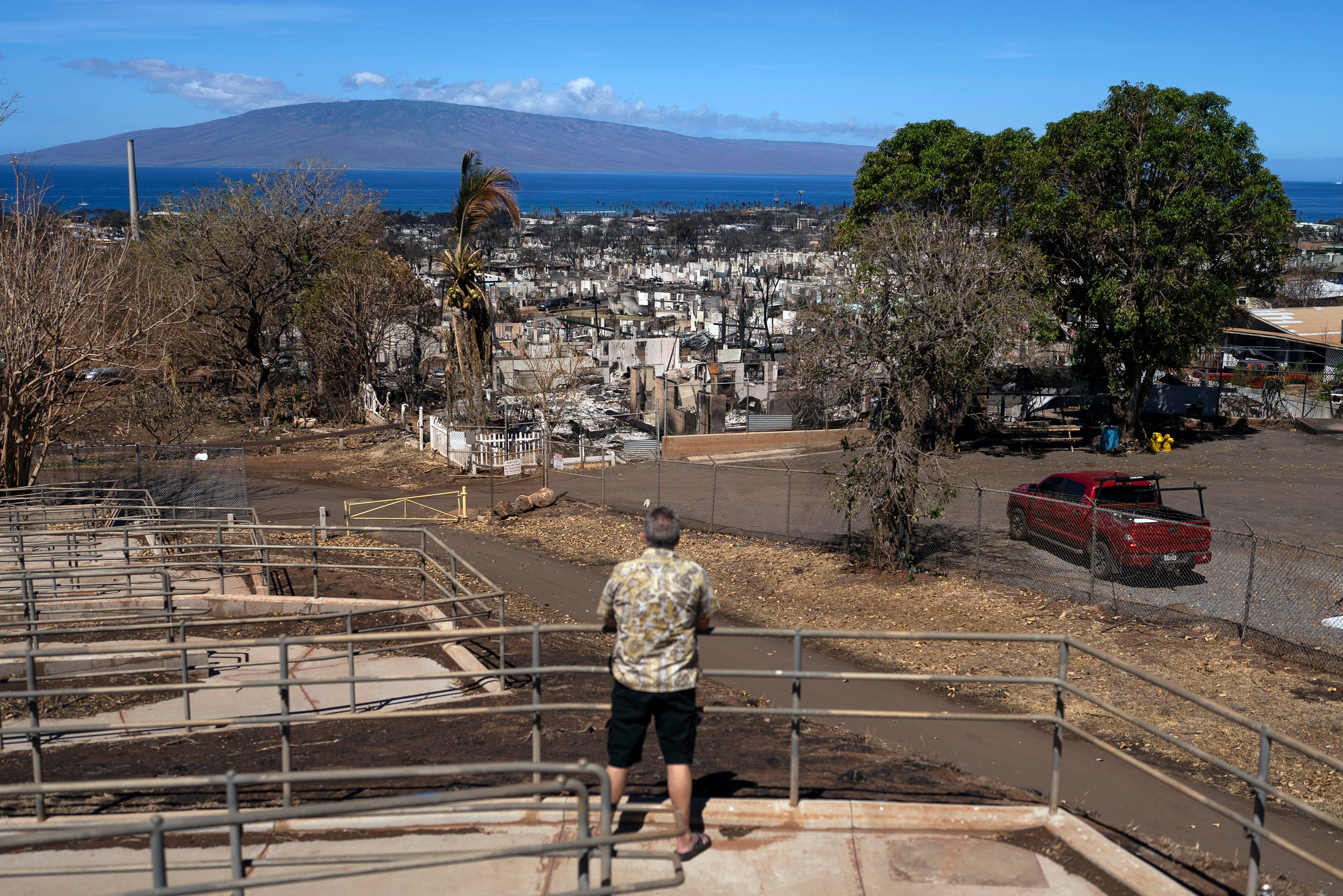 A man views homes consumed by a wildfire in Lahaina