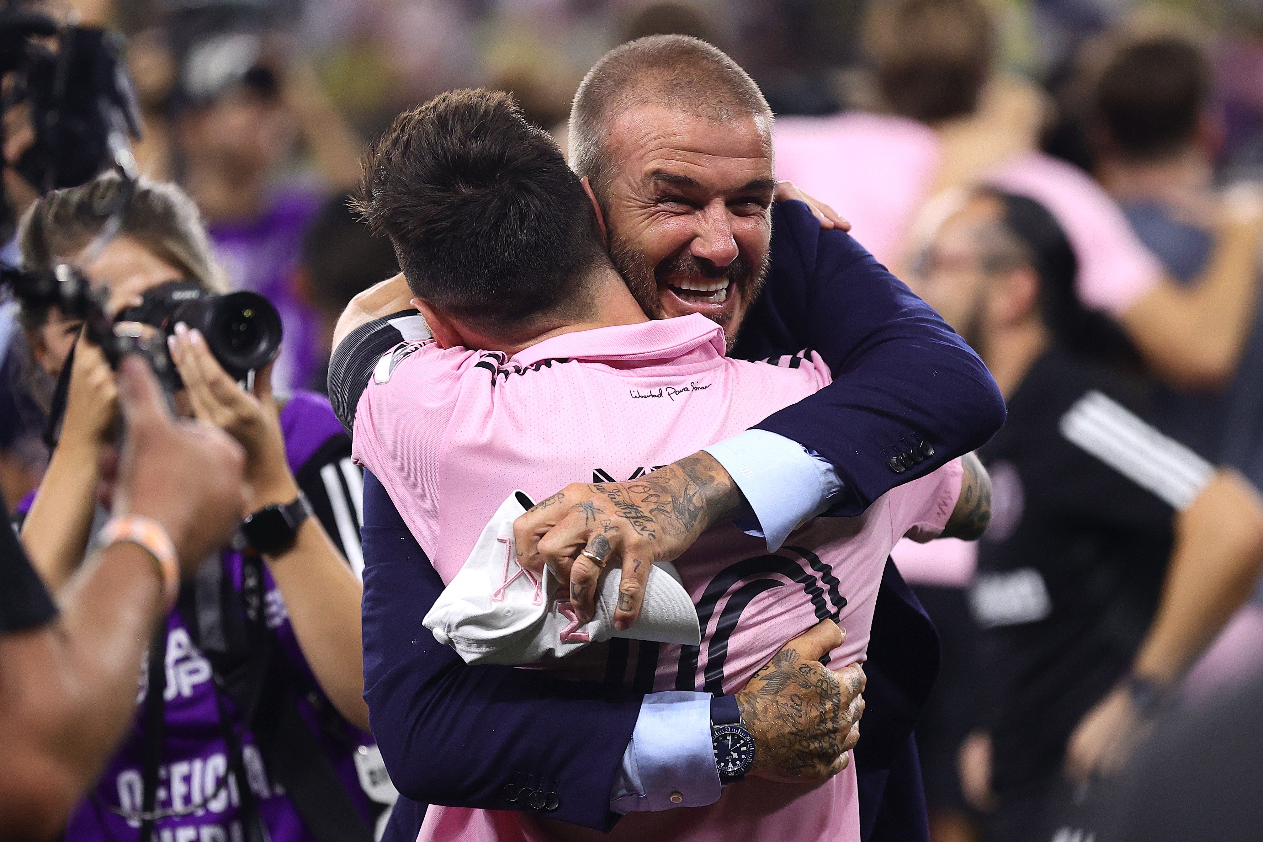 David Beckham and Lionel Messi embrace after victory