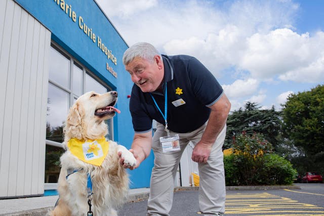Dog Sandi and her owner Alistair King are boosting the spirits of Marie Curie patients (Phil Smyth/Marie Curie/PA)