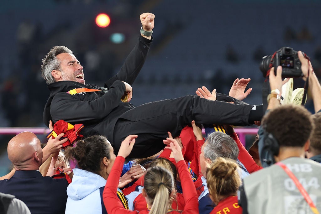 Vilda lifted up by his support staff and some players after Spain’s win