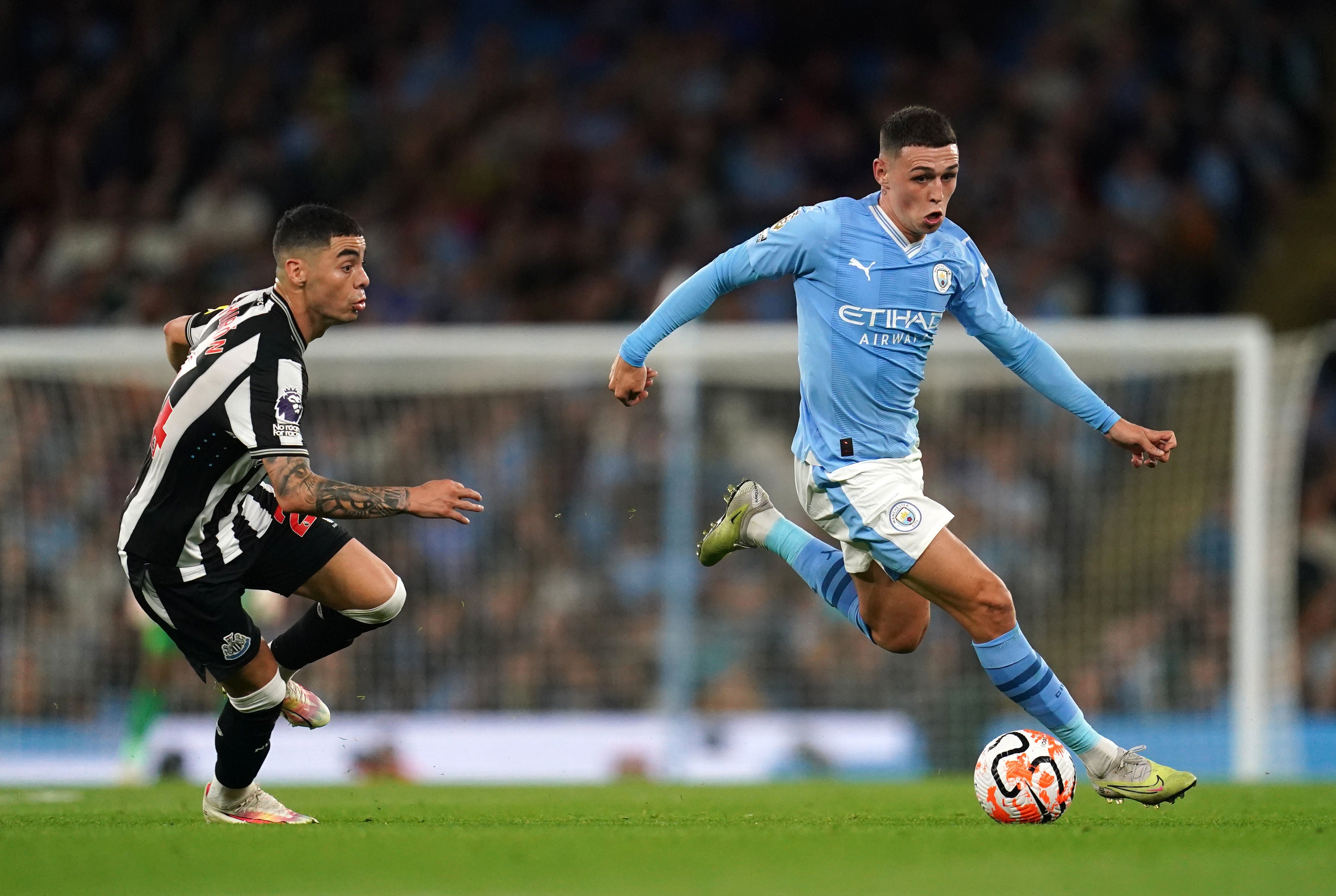  Phil Foden, a young English soccer player, playing as a left winger for Manchester City, dribbles the ball past an opposing player during a match.
