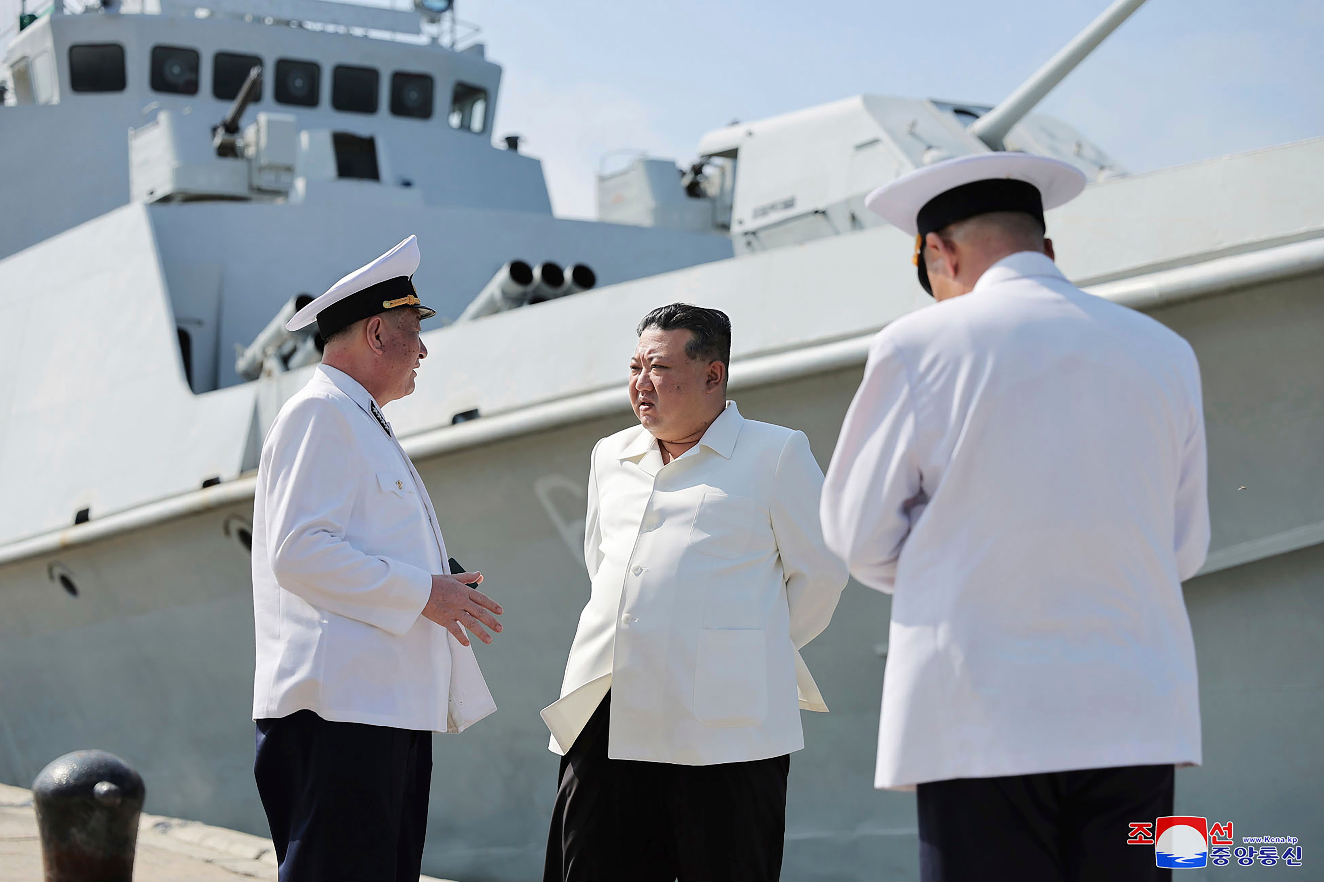 In this undated photo provided on Monday, 21 August 2023, by the North Korean government, North Korean leader Kim Jong-un, centre, visits a navy flotilla in North Korea