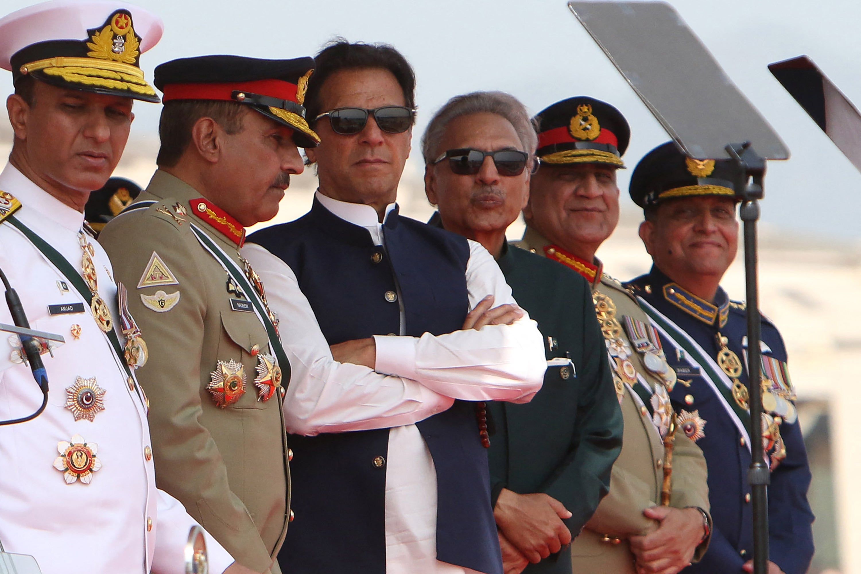 File: Pakistan’s former prime minister Imran Khan (3L) and president Arif Alvi (3R) watch Pakistan’s Air Force fighter jets perform during the Pakistan Day parade in Islamabad