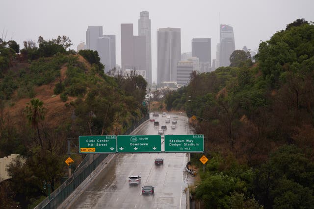 <p>Vehicles drive towards downtown Los Angeles in the rain as Tropical Storm Hilary arrives in Los Angeles, California, USA, 20 August 2023</p>