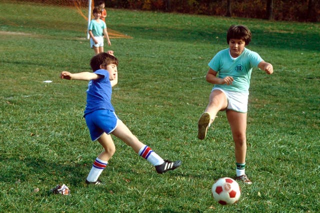 <p>Glory days: Children play football together in the halycon days of 1983</p>
