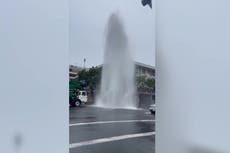 Jet of water bursts through road in downtown San Diego