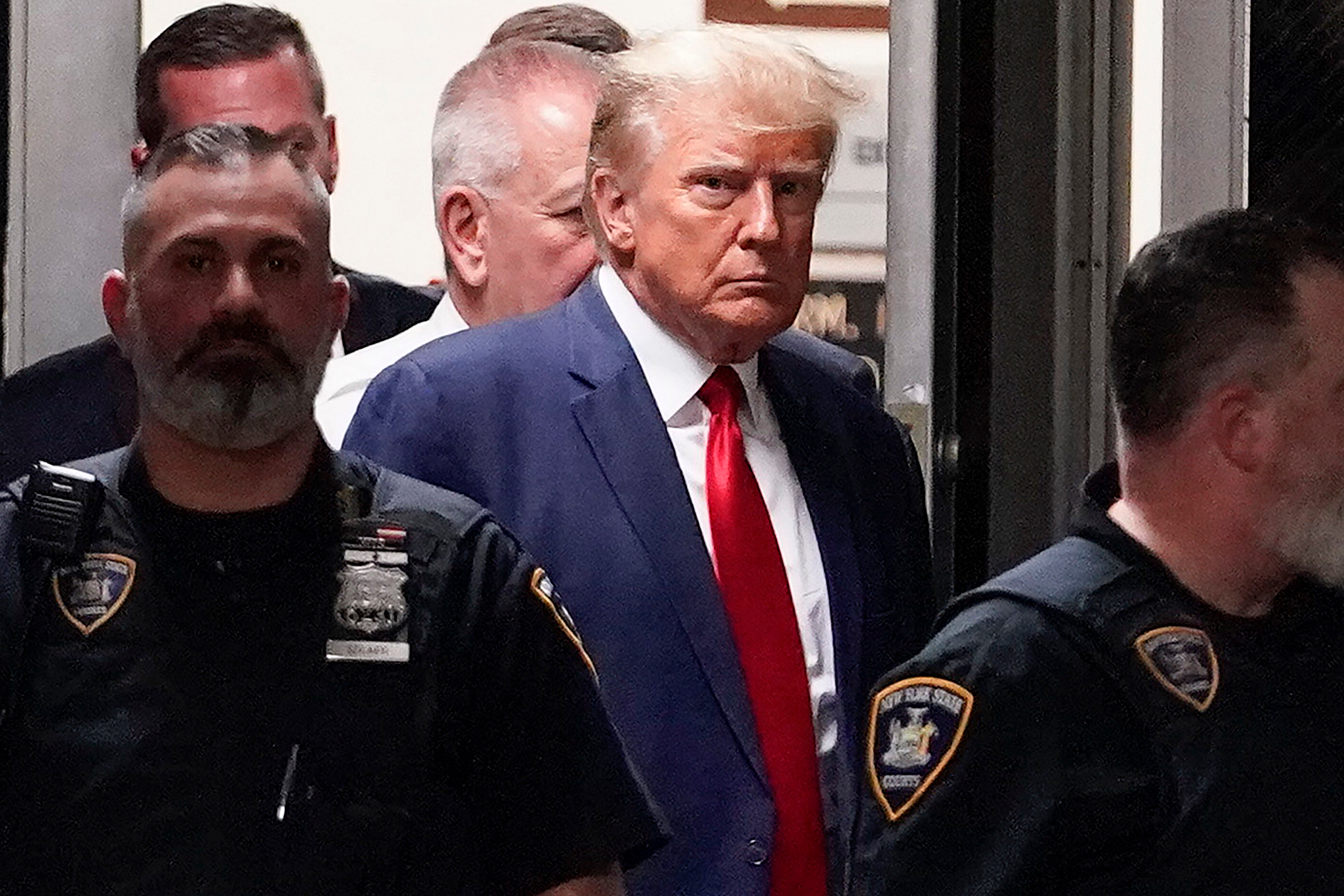 Former president Donald Trump is escorted into a New York courtroom on 4 April 2023 to answer to the state indictment accusing him of falsifying business records to conceal a hush money payment made to porn star Stormy Daniels