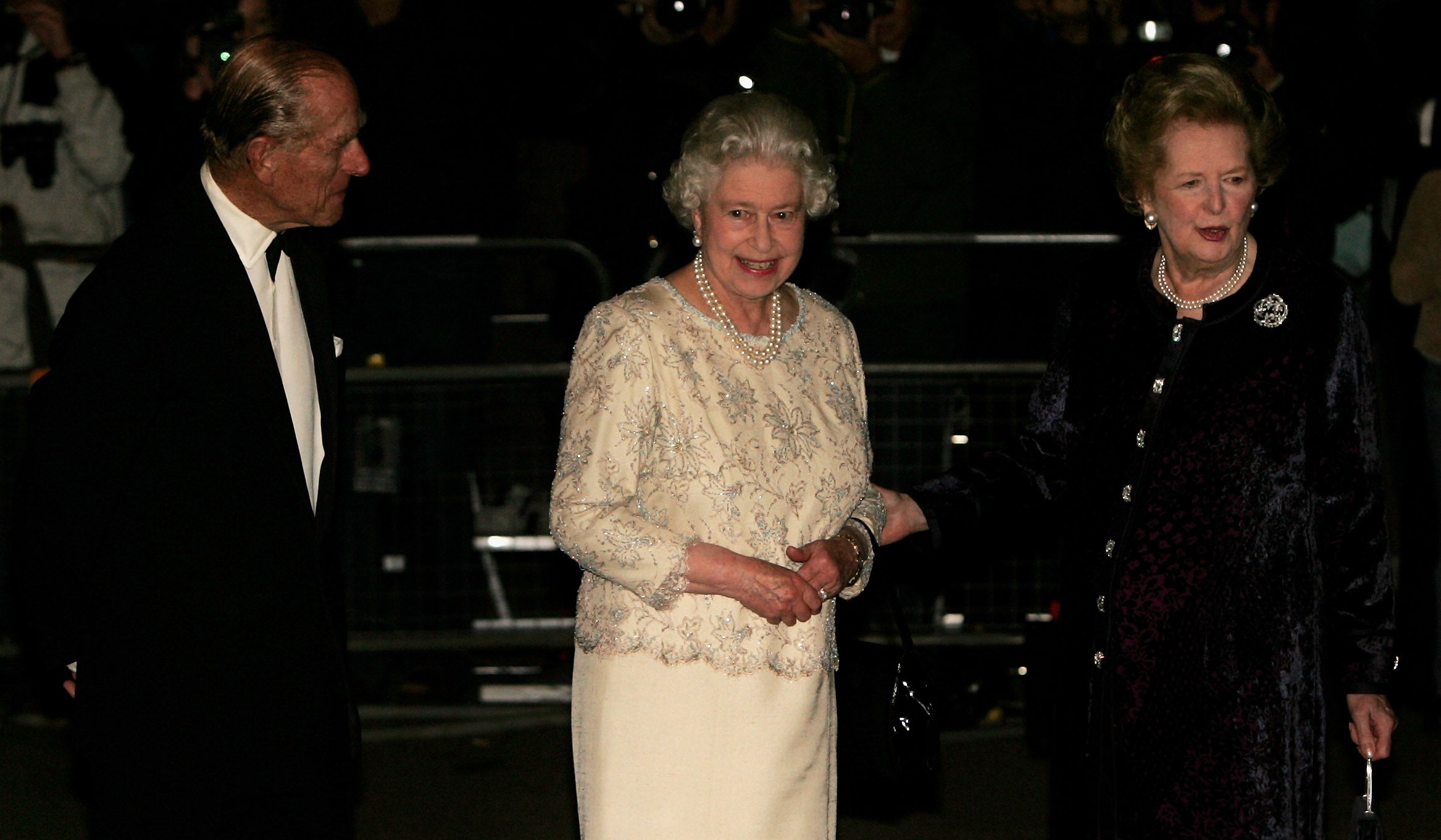 Former British Prime Minister Baroness Margaret Thatcher (R) greets HM Queen Elizabeth II and Prince Philip, Duke of Edinburgh, as they arrive for Thatcher's 80th birthday party at the Mandarin Oriental on October 13, 2005