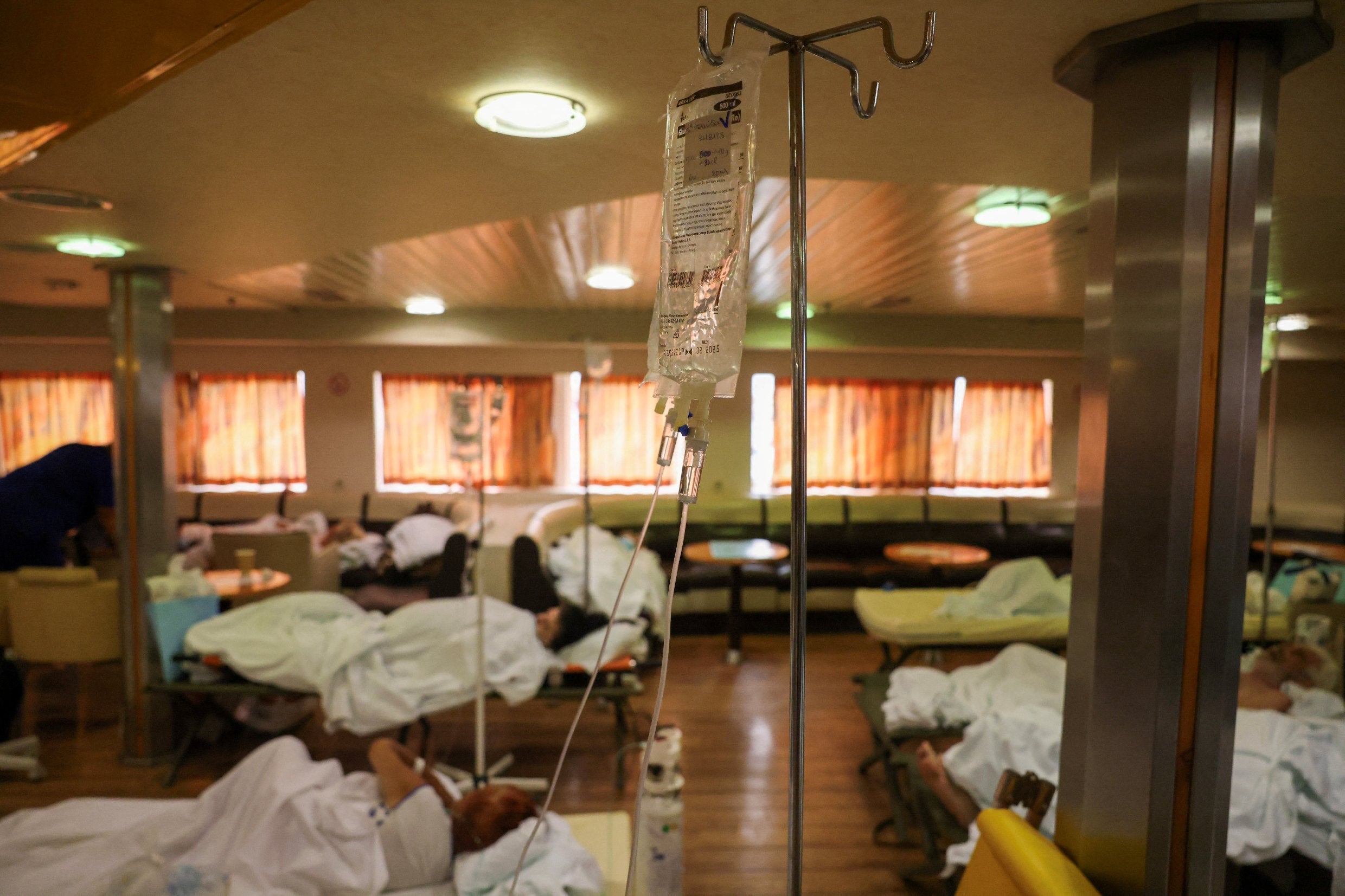 Patients from the General University Hospital of Alexandroupolis are seen inside a ferry after being evacuated