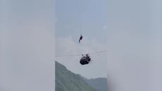 Rescuer dangles 900ft over ravine as he tries to help children trapped in Pakistan cable car