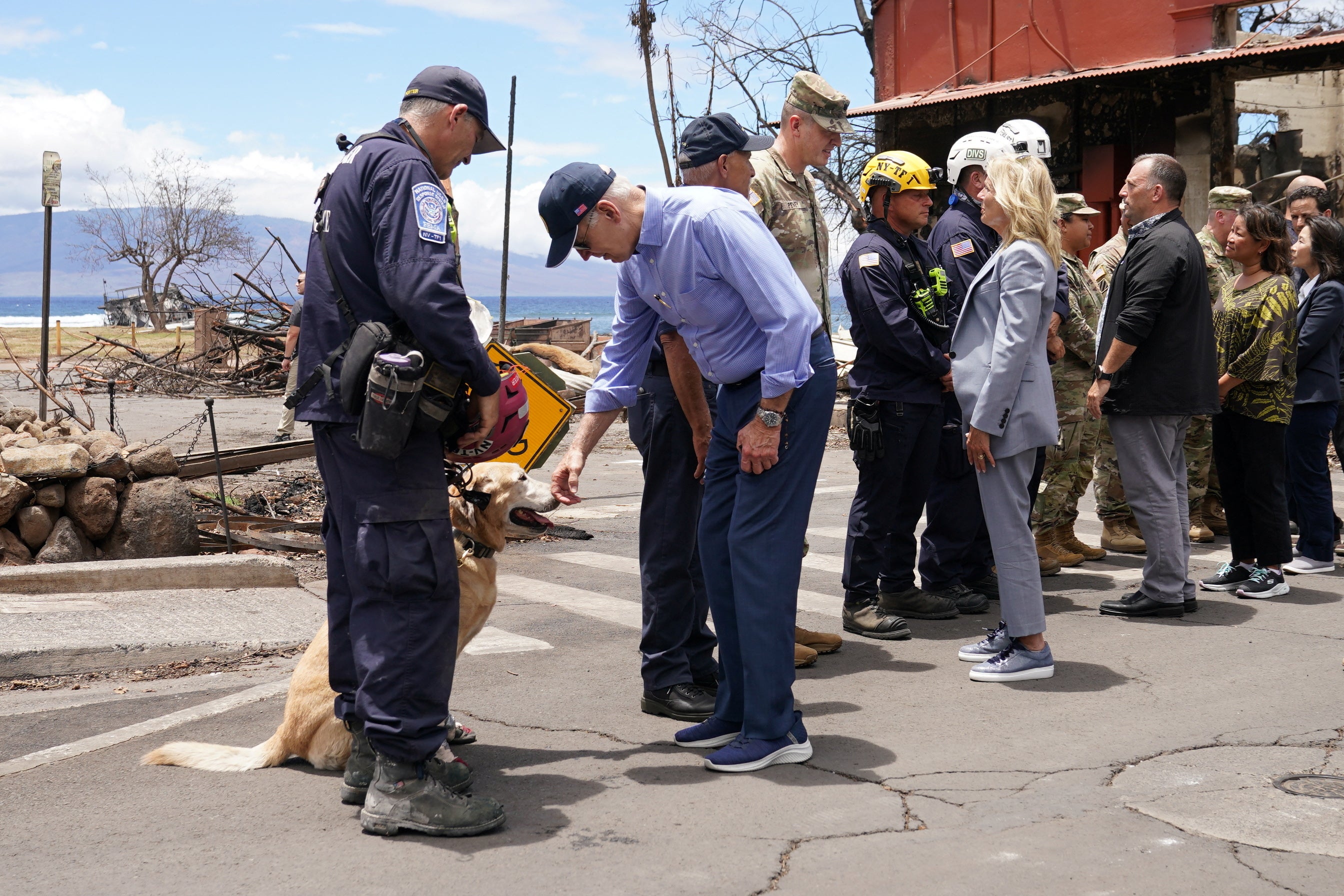 U.S. President Joe Biden and first lady Jill Biden meet first responders and a rescue dog in the fire-ravaged town of Lahaina