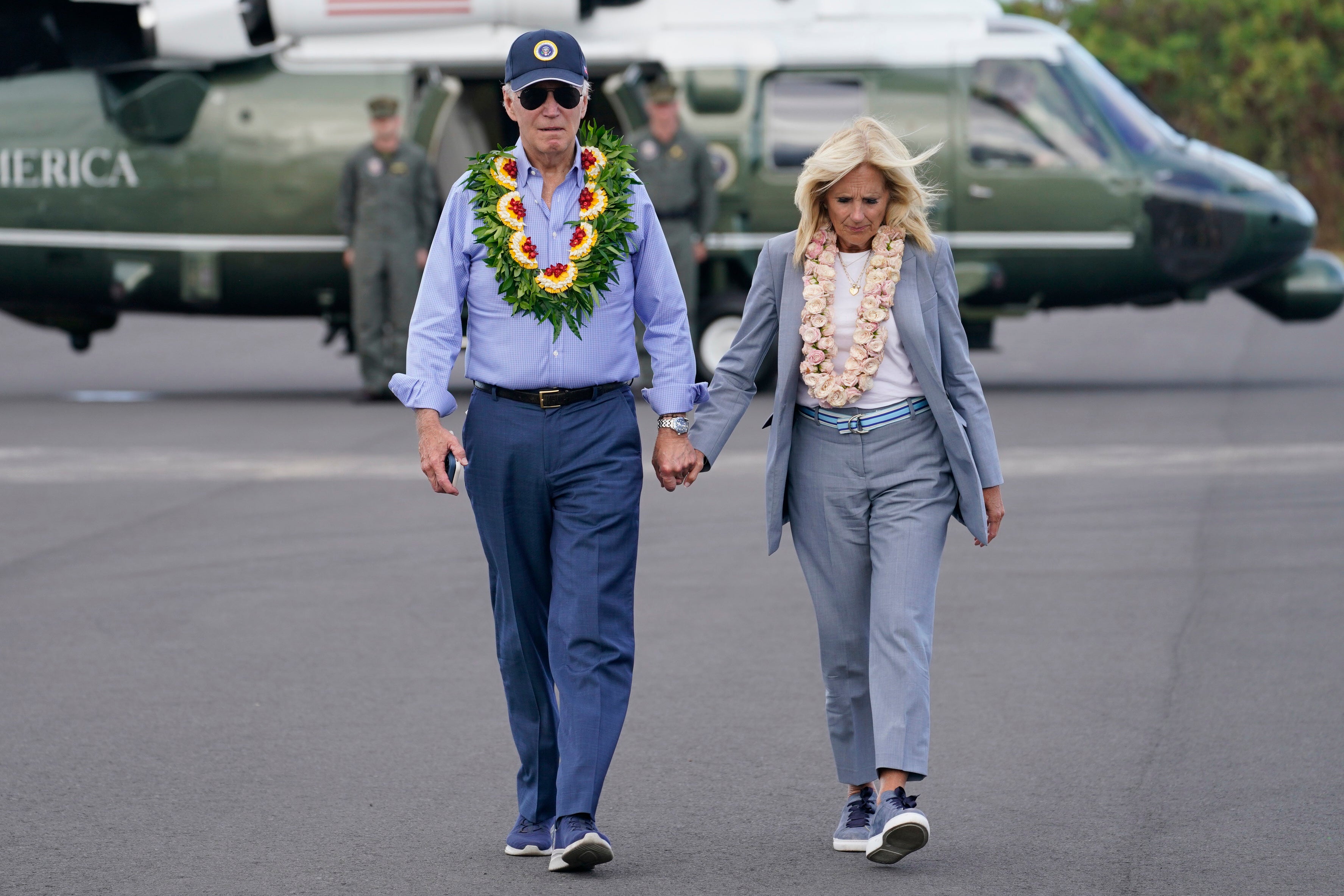 President Joe Biden and first lady Jill Biden walk to board Air Force One after visiting the site of the devastating Maui wildfires