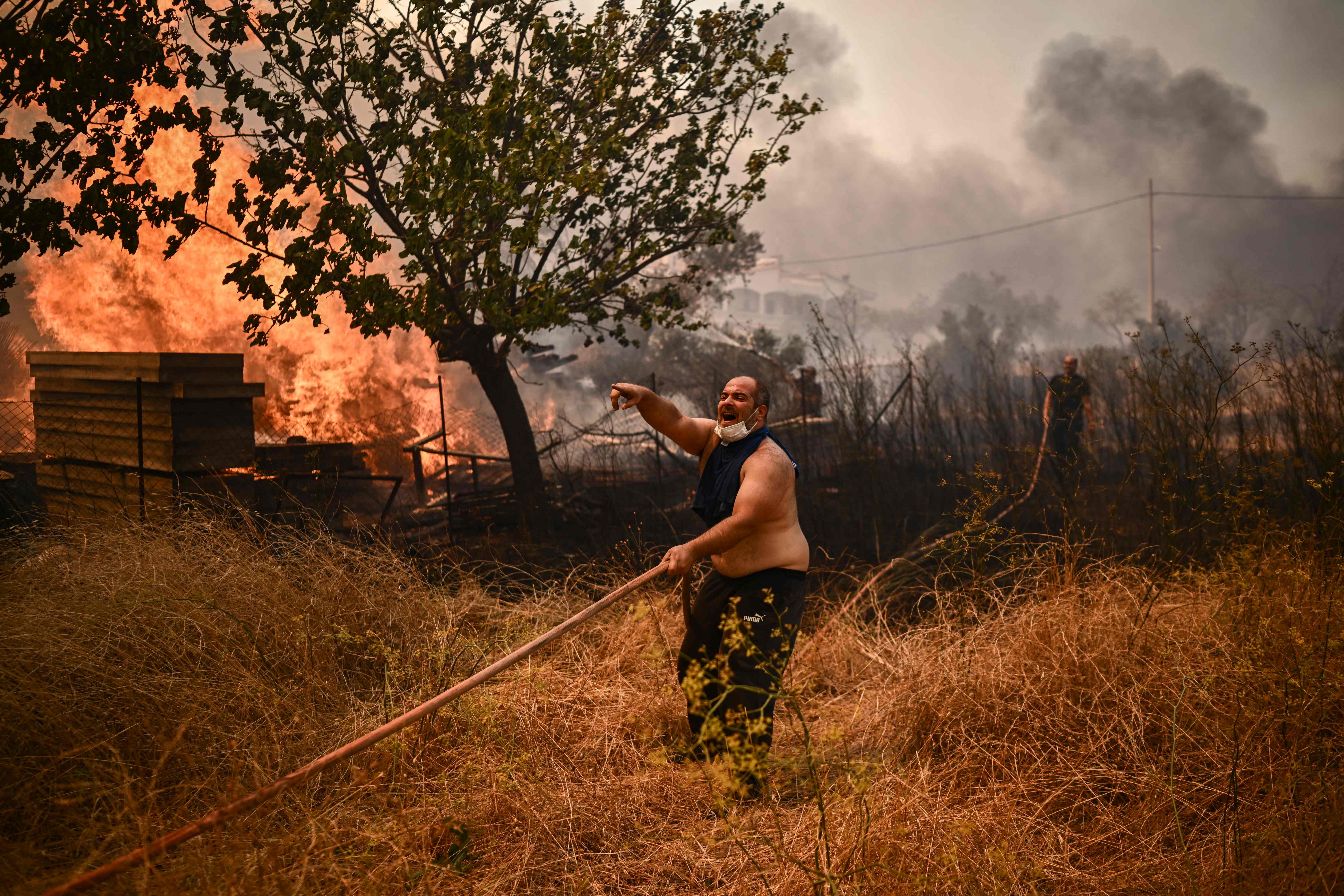 Frantic efforts to fight a wildfire in Chasia near Athens on Tuesday