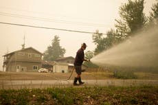 Canadian officials ease wildfire evacuation orders in scenic British Columbia region