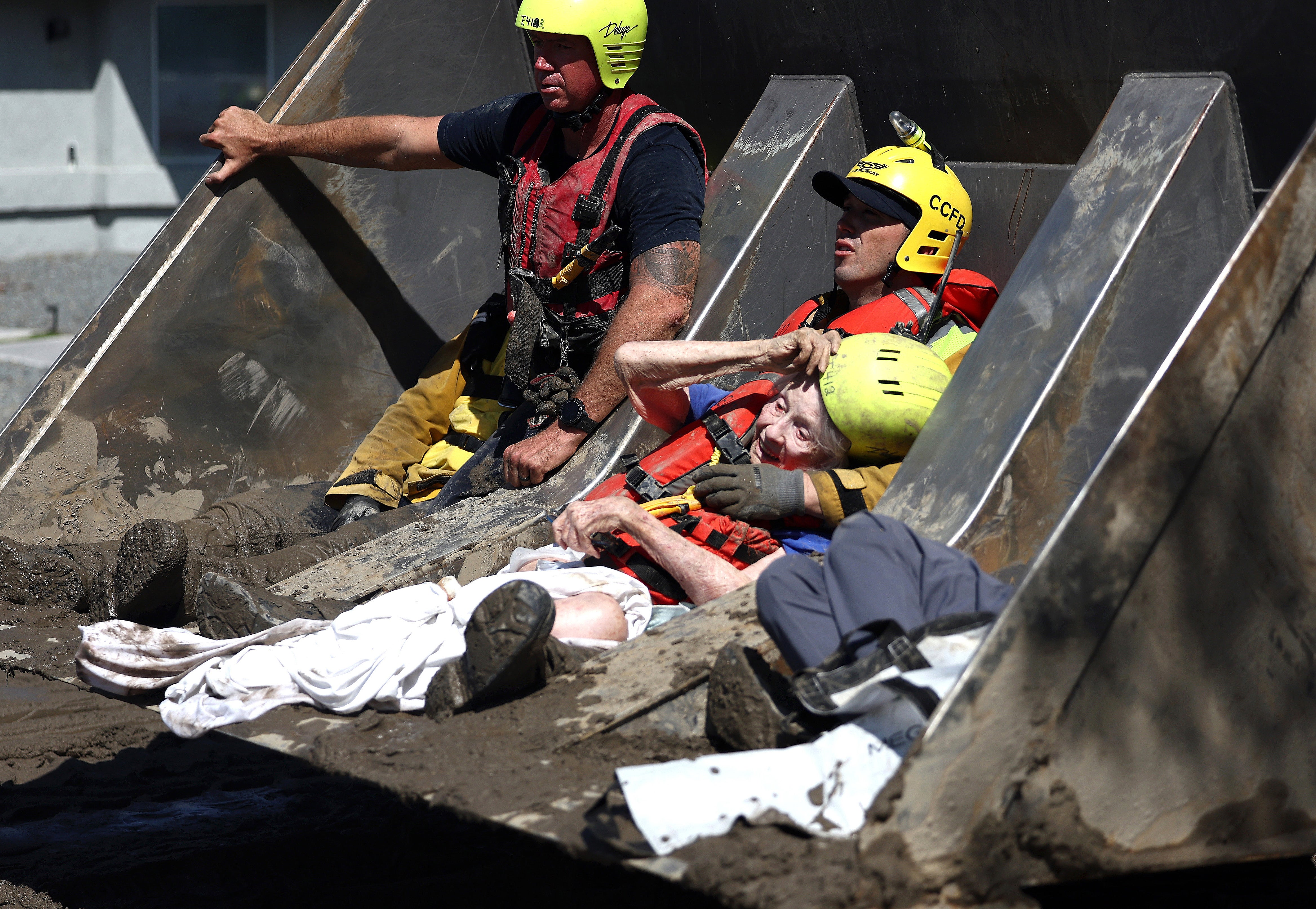 Elderly residents are rescued by members of the Cathedral City Fire Department in a bulldozer after Tropical Storm Hilary flooded the area on August 21, 2023