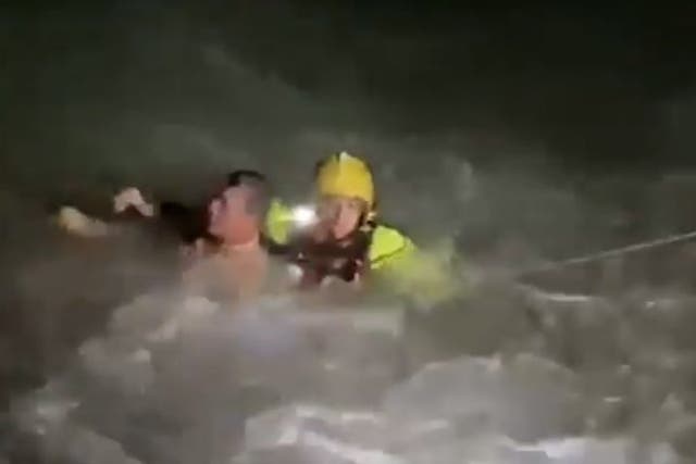 <p>Swimmer battered by treacherous sea waves in darkness.</p>