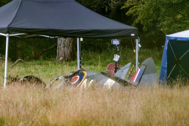<p>Police and emergency responders at the scene of an aircraft crash in a field near Enstoe</p>