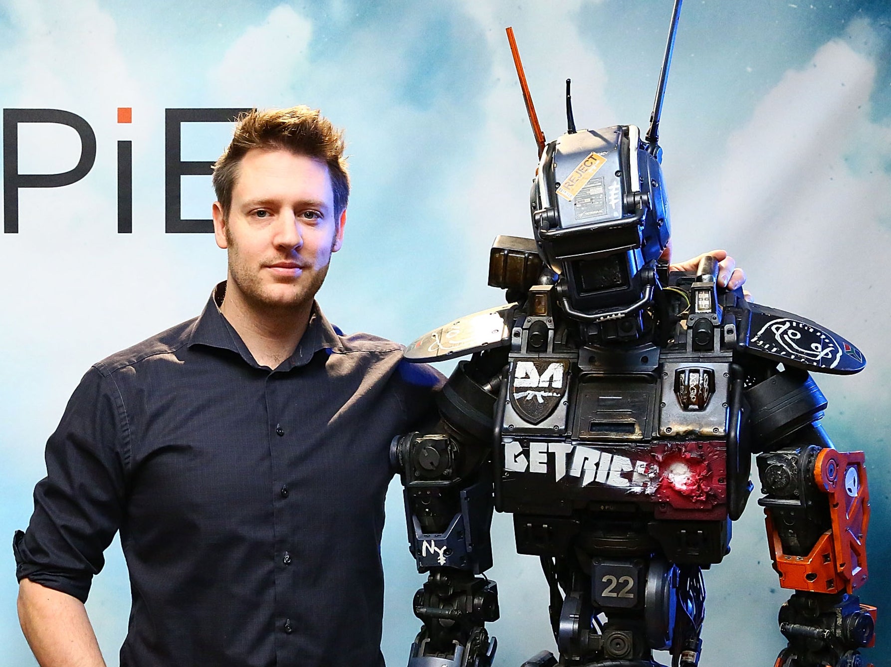 Blomkamp poses with the ‘Chappie' prop in 2015