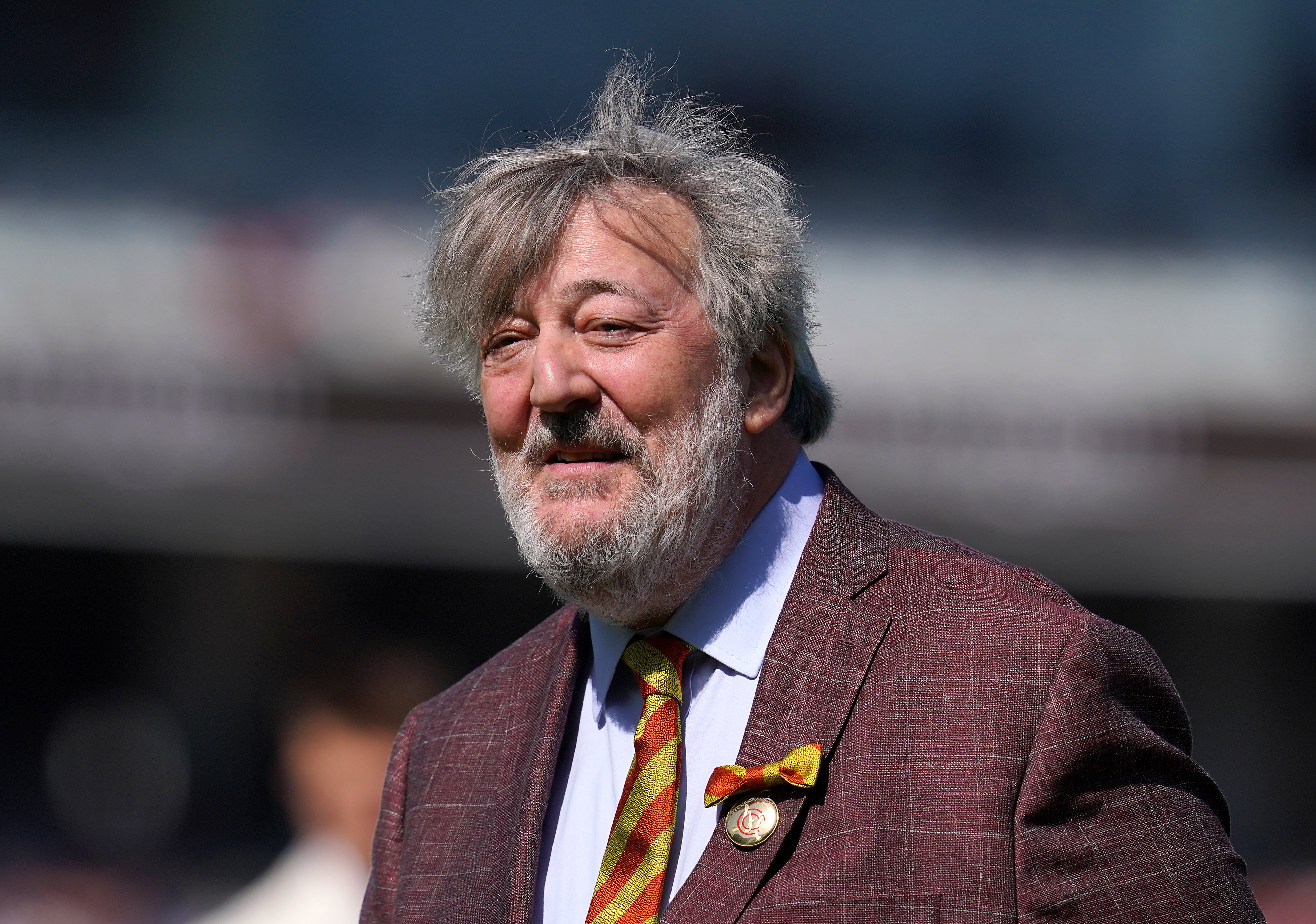 Stephen Fry fell around six feet from a stage while presenting a talk about AI
